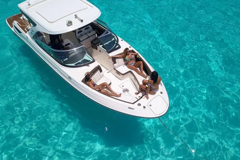 Slide: The Image of 2017 Sea Ray SLX 350 boat with passengers relaxing on clear turquoise water. - 8