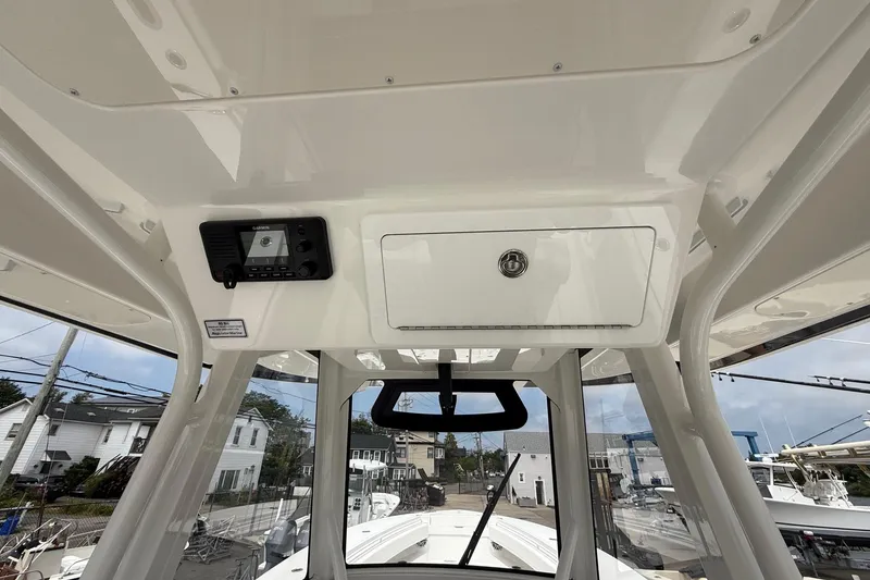 Slide: The Image of 2026 Regulator 31 boat interior with control panel and storage compartment. - 11