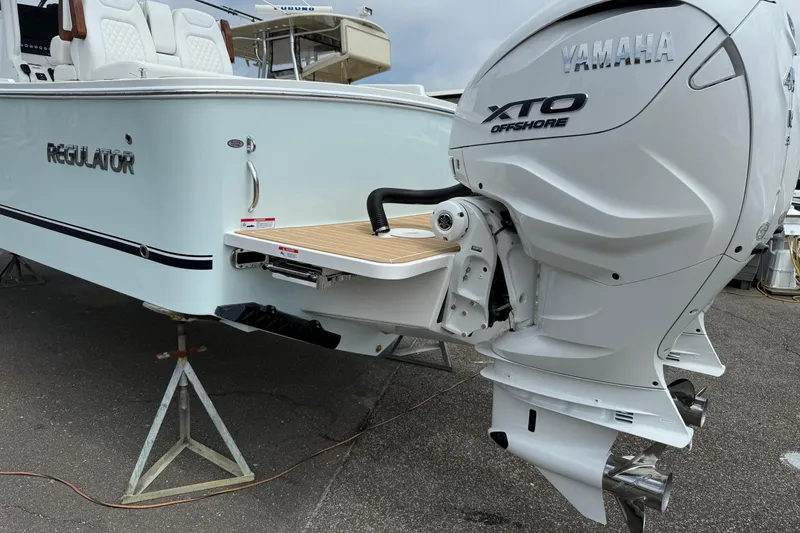 Slide: The Image of 2026 Regulator 31 boat with Yamaha XTO Offshore engine, displayed on stands. - 14