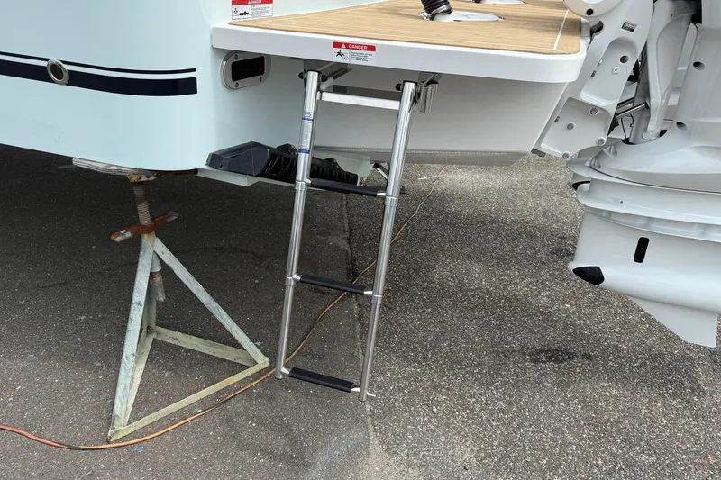 Slide: The Image of 2026 Regulator 31 boat with ladder and outboard motor on display. - 15