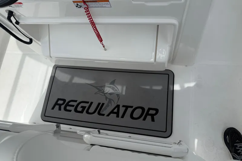 Slide: The Image of 2026 Regulator 31 boat interior with branded mat and safety features. - 17