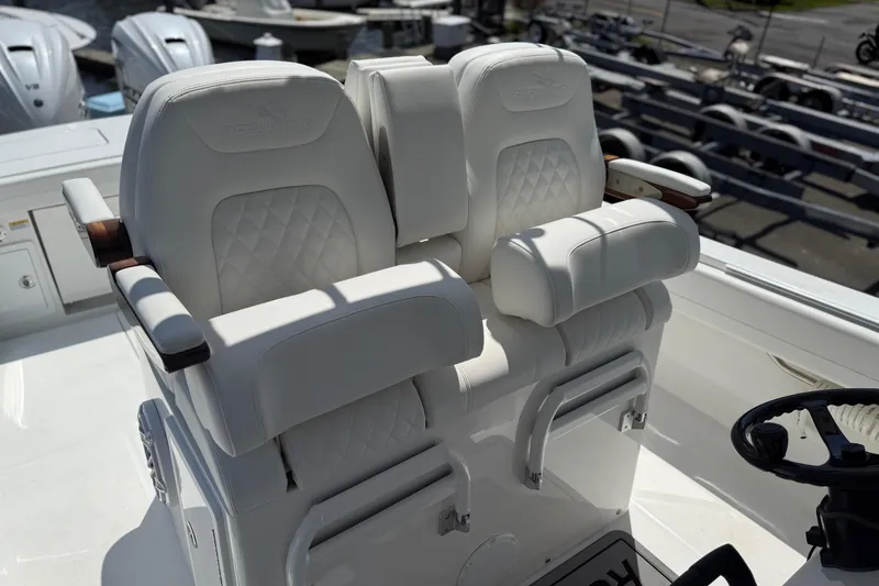 Slide: The Image of Luxury seating on 2026 Regulator 31 boat, featuring plush white upholstery and armrests. - 2