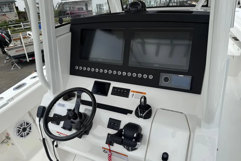 Slide: The Image of 2026 Regulator 31 boat dashboard with dual screens and steering wheel. - 22