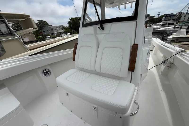 Slide: The Image of 2026 Regulator 31 boat with white cushioned seating and sleek design. - 25