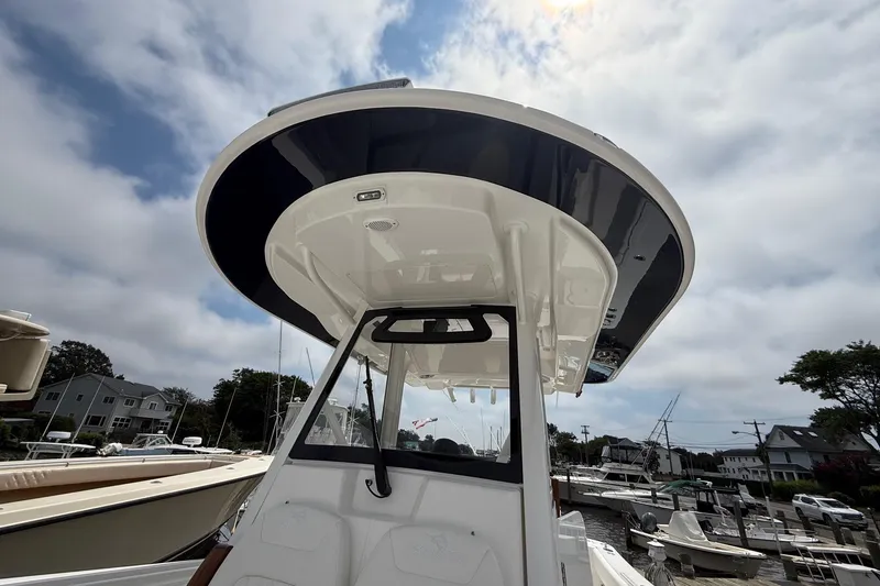 Slide: The Image of 2026 Regulator 31 boat with sleek design, docked under a cloudy sky. - 26