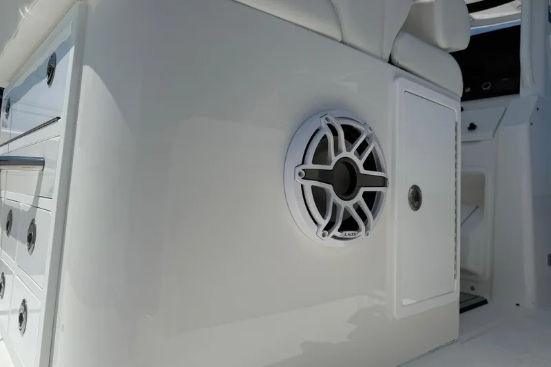 Slide: The Image of 2026 Regulator 31 boat interior with JL Audio speaker and storage compartments. - 28
