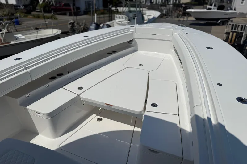 Slide: The Image of 2026 Regulator 31 boat interior with sleek white seating and storage compartments. - 30