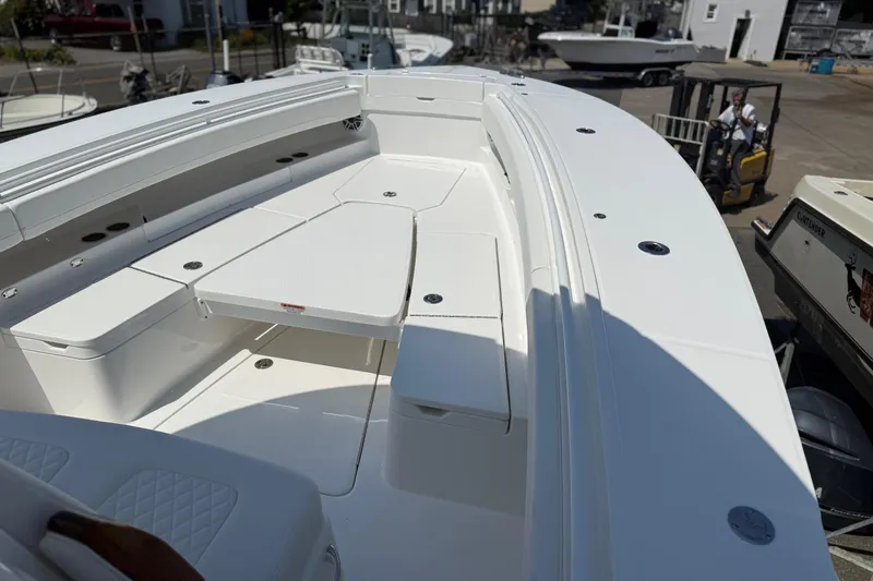 Slide: The Image of 2026 Regulator 31 boat with spacious seating and sleek design in a marina setting. - 31