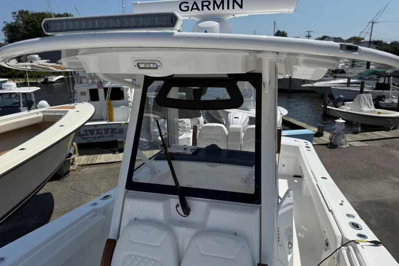 Slide: The Image of 2026 Regulator 31 boat with Garmin equipment at a marina dock. - 33