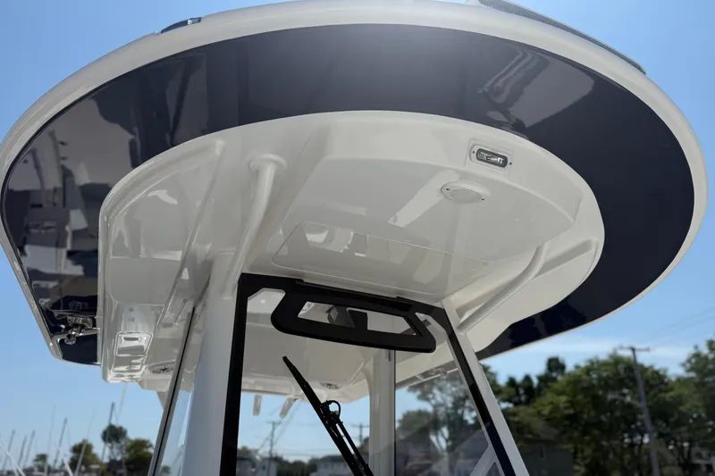 Slide: The Image of 2026 Regulator 31 boat's T-top structure under clear blue sky. - 35