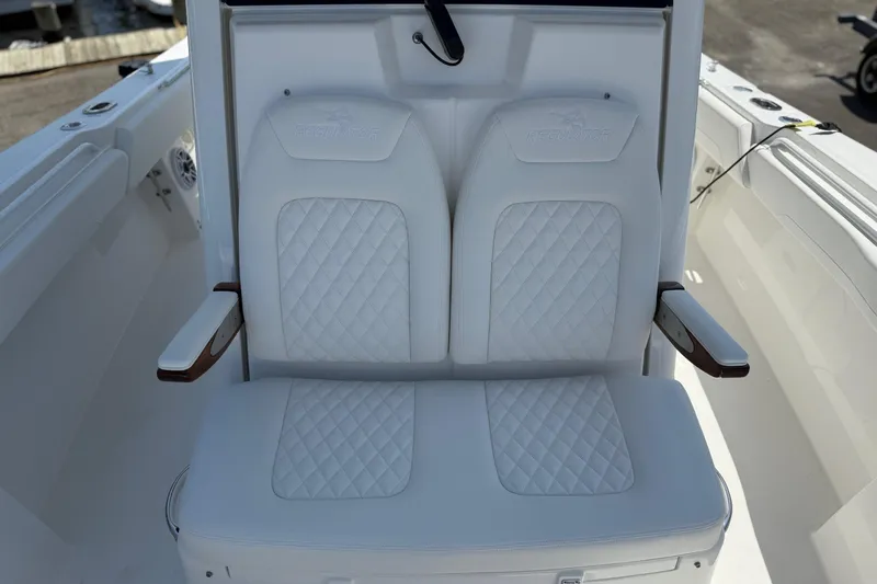 Slide: The Image of 2026 Regulator 31 boat with white cushioned seating and armrests. - 38