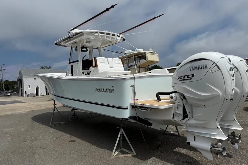 Slide: The Image of 2026 Regulator 31 boat with Yamaha XTO engines on display outdoors. - 4