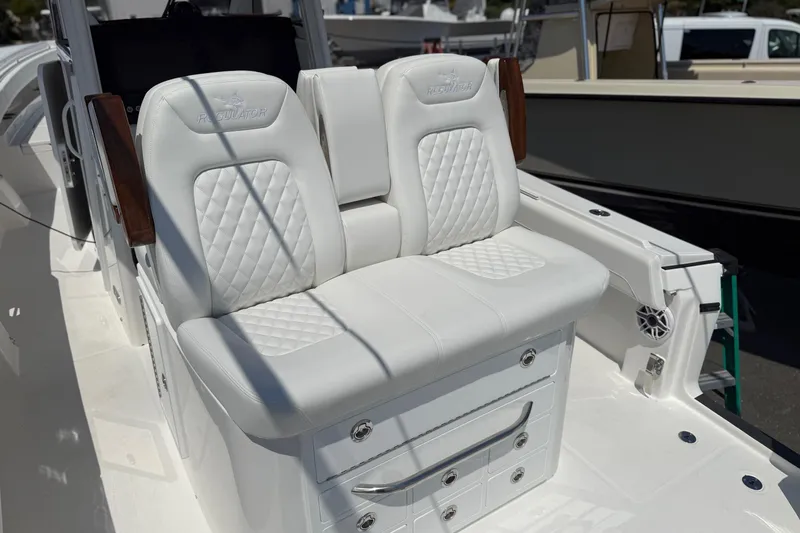 Slide: The Image of 2026 Regulator 31 boat with luxurious white seating and storage drawers. - 41
