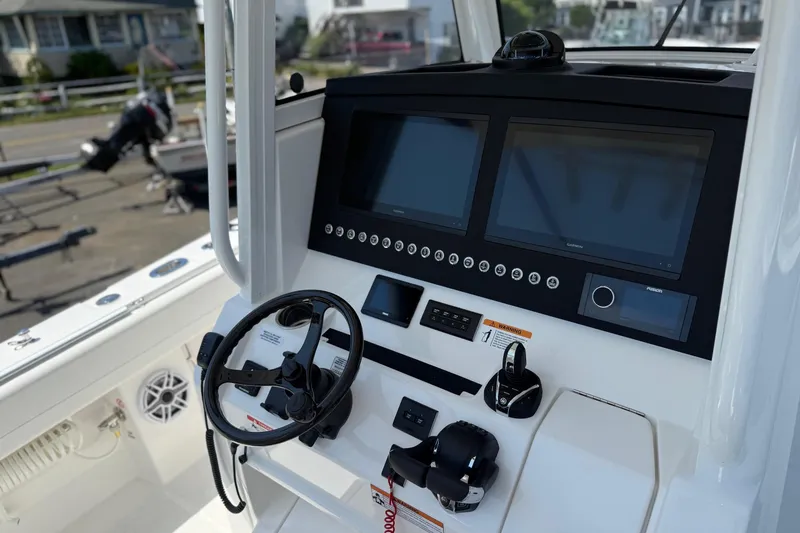 Slide: The Image of 2026 Regulator 31 boat dashboard with dual screens and steering wheel. - 42