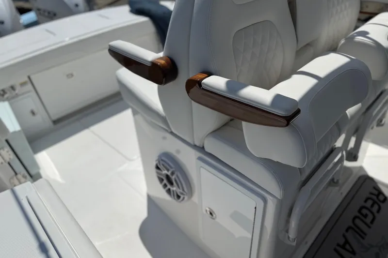 Slide: The Image of Luxurious seating on 2026 Regulator 31 boat with elegant armrests and speaker. - 44