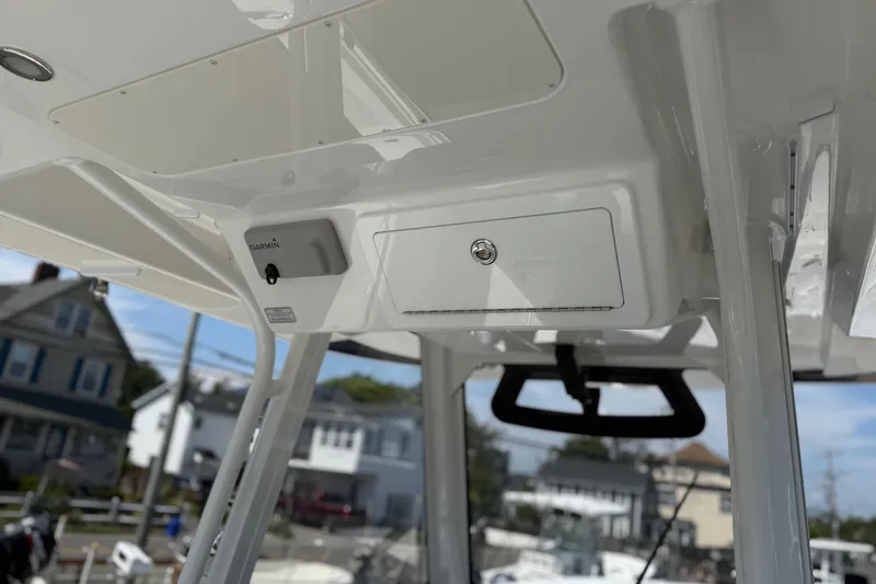 Slide: The Image of 2026 Regulator 31 boat console with Garmin equipment, docked in a residential area. - 45