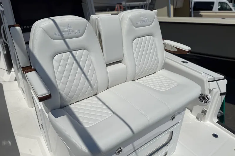 Slide: The Image of Luxury white seating on 2026 Regulator 31 boat, featuring quilted design and armrests. - 47