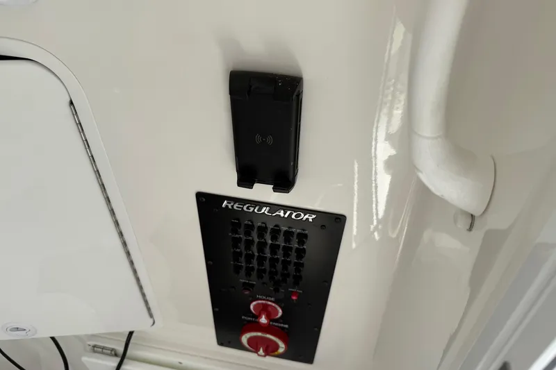 Slide: The Image of Control panel of 2026 Regulator 31 boat with switches and phone holder. - 51