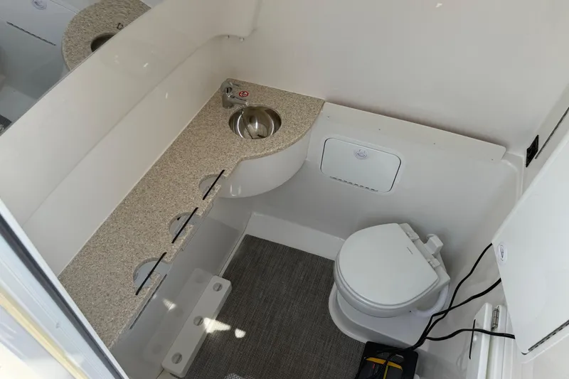 Slide: The Image of 2026 Regulator 31 boat bathroom with sink, toilet, and countertop. - 54