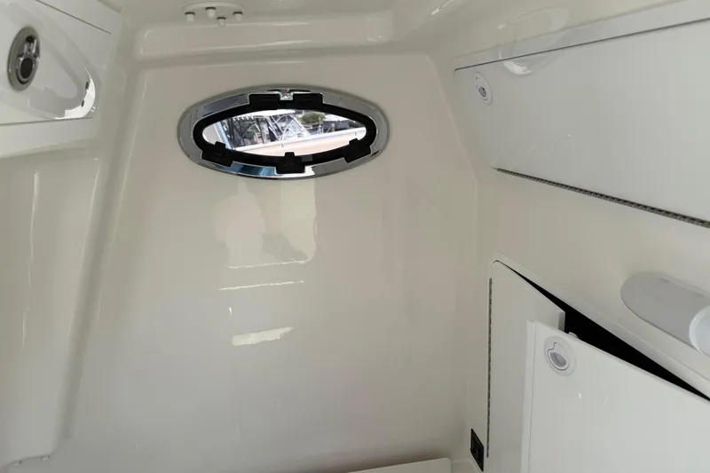 Slide: The Image of Interior cabin of 2026 Regulator 31 boat with oval window and storage compartments. - 55