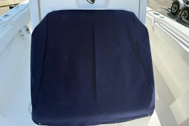 Slide: The Image of 2026 Regulator 31 boat with a navy blue seat cover. - 58