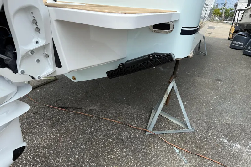 Slide: The Image of 2026 Regulator 31 boat on stands, showcasing rear hull and outboard motor details. - 7