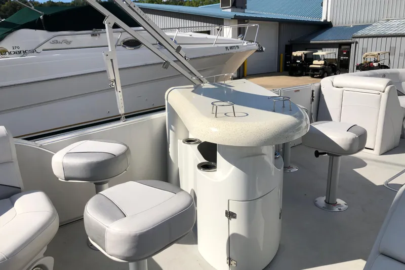 Slide: The Image of 2015 Avalon Catalina Entertainer boat interior with bar and seating area. - 10