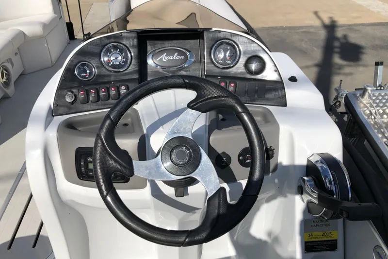 Slide: The Image of Steering console of 2015 Avalon Catalina Entertainer 25' boat with gauges and controls. - 12