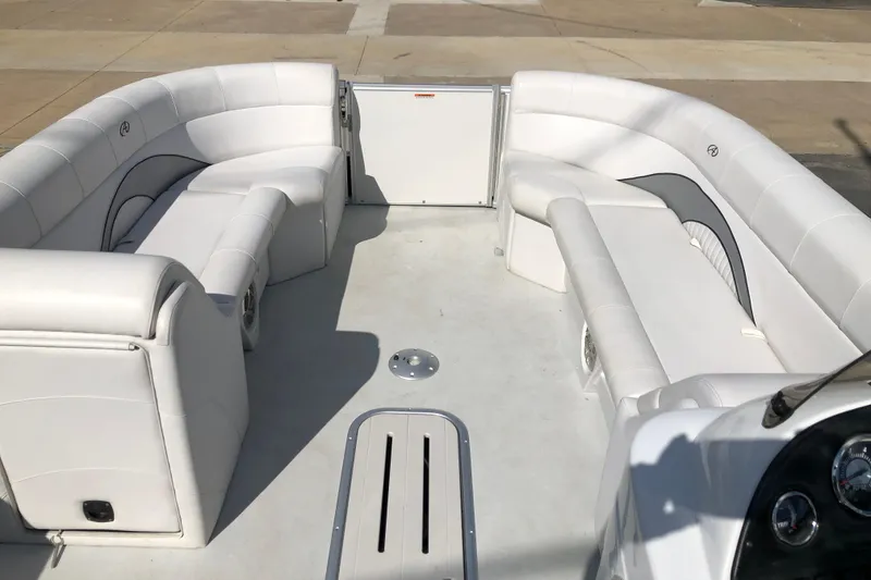 Slide: The Image of 2015 Avalon Catalina Entertainer boat interior with white seating and spacious layout. - 13