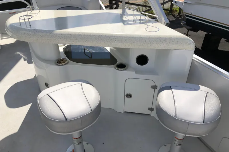 Slide: The Image of 2015 Avalon Catalina Entertainer boat bar area with stools and countertop. - 6