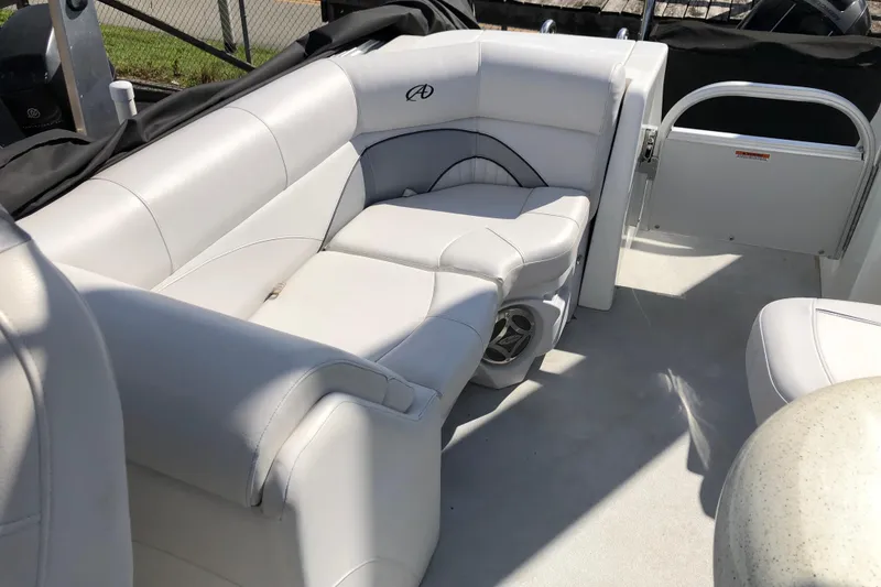 Slide: The Image of 2015 Avalon Catalina Entertainer boat interior with white seating and speaker. - 7