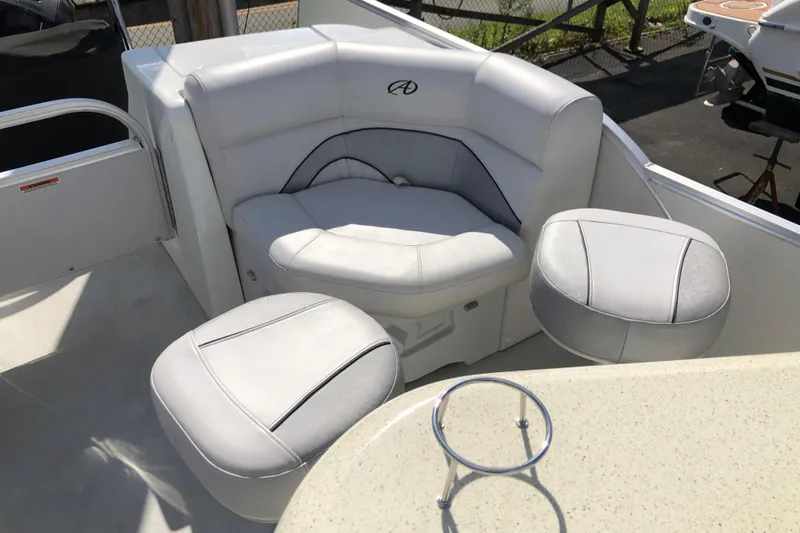 Slide: The Image of Luxurious seating on 2015 Avalon Catalina Entertainer 25' boat, featuring plush white upholstery. - 8