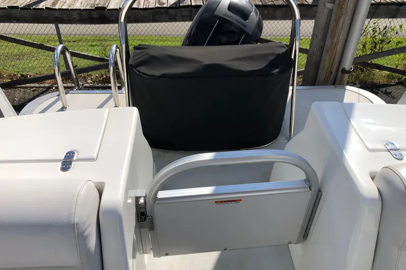 Slide: The Image of 2015 Avalon Catalina Entertainer boat interior with seating and covered engine. - 9