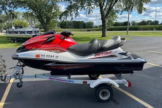 Slide: The Image of 2012 Kawasaki Ultra LX jet ski on trailer, parked outdoors. - 4