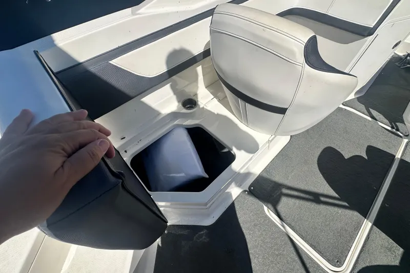 Slide: The Image of 2018 Sea Ray SPX 210 boat interior with storage compartment and seating. - 13