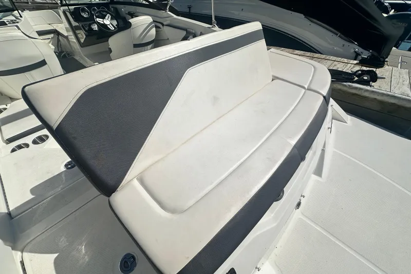 Slide: The Image of 2018 Sea Ray SPX 210 boat interior with white and black seating. - 16