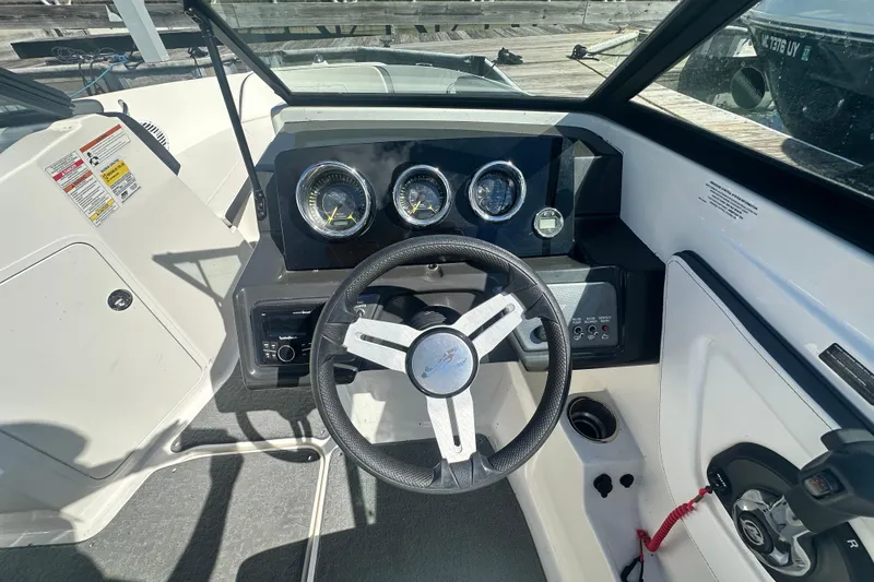 Slide: The Image of 2018 Sea Ray SPX 210 boat dashboard with steering wheel and instrument panel. - 17