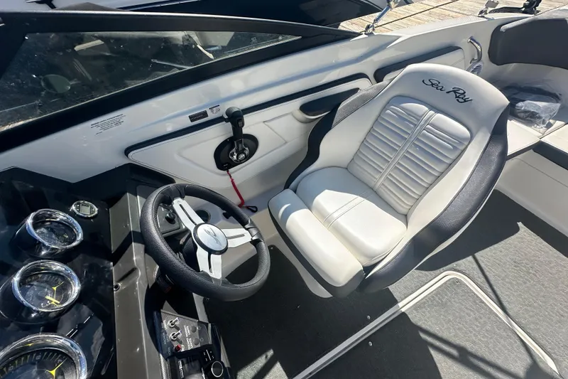 Slide: The Image of 2018 Sea Ray SPX 210 boat interior with steering wheel and captain's seat. - 19