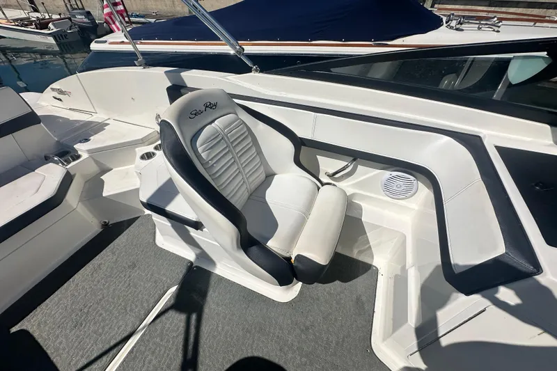 Slide: The Image of 2018 Sea Ray SPX 210 boat interior with white captain's chair and sleek design. - 20