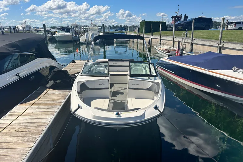 Slide: The Image of 2018 Sea Ray SPX 210 boat docked at marina under clear blue sky. - 4