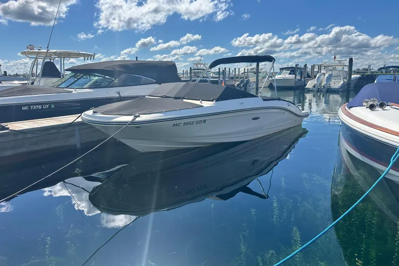 Slide: The Image of 2018 Sea Ray SPX 210 boat docked in a marina under a clear blue sky. - 7