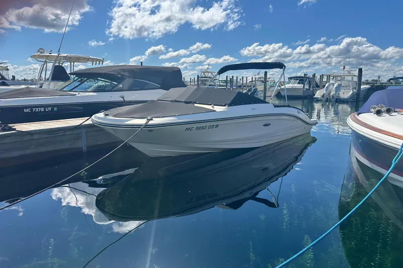 Slide: The Image of 2018 Sea Ray SPX 210 boat docked in a marina under a clear blue sky. - 9