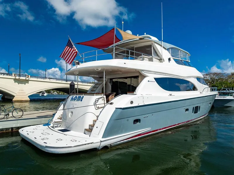 Slide: The Image of 2013 Hatteras 80 Motor Yacht docked, featuring sleek design and American flag. - 10