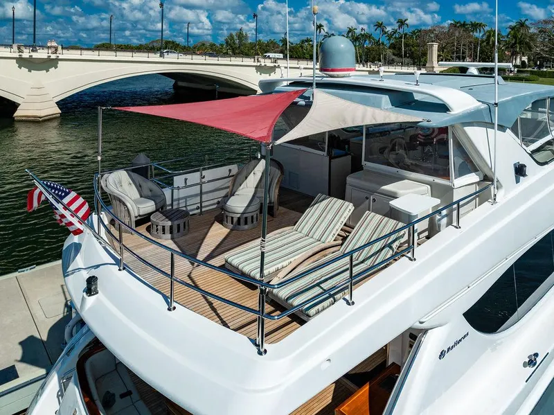 Slide: The Image of 2013 Hatteras 80 Motor Yacht with sun deck, lounge chairs, and bridge view. - 11