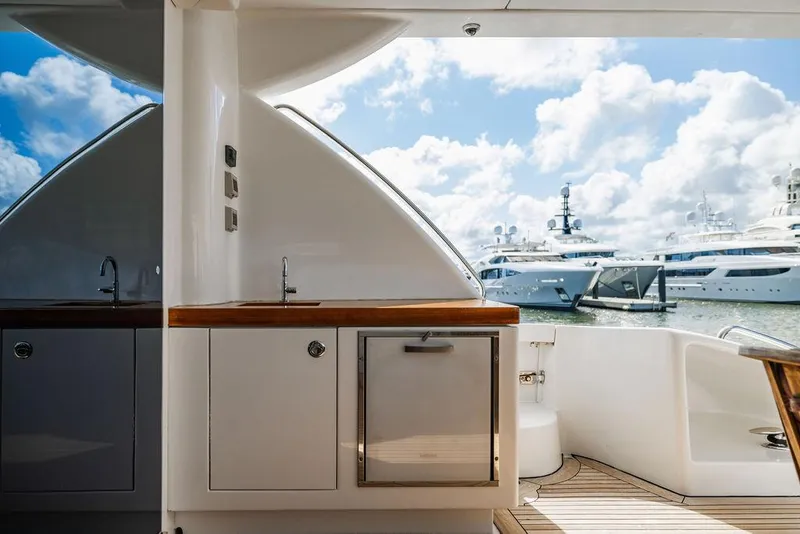 Slide: The Image of 2013 Hatteras 80 Motor Yacht deck with marina view and blue sky. - 23