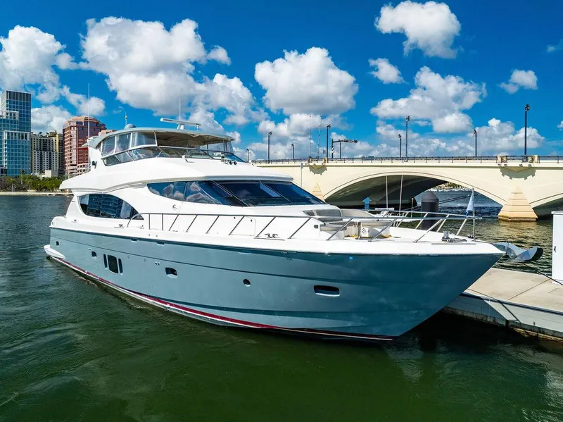 Slide: The Image of 2013 Hatteras 80 Motor Yacht docked near a bridge under a blue sky. - 4
