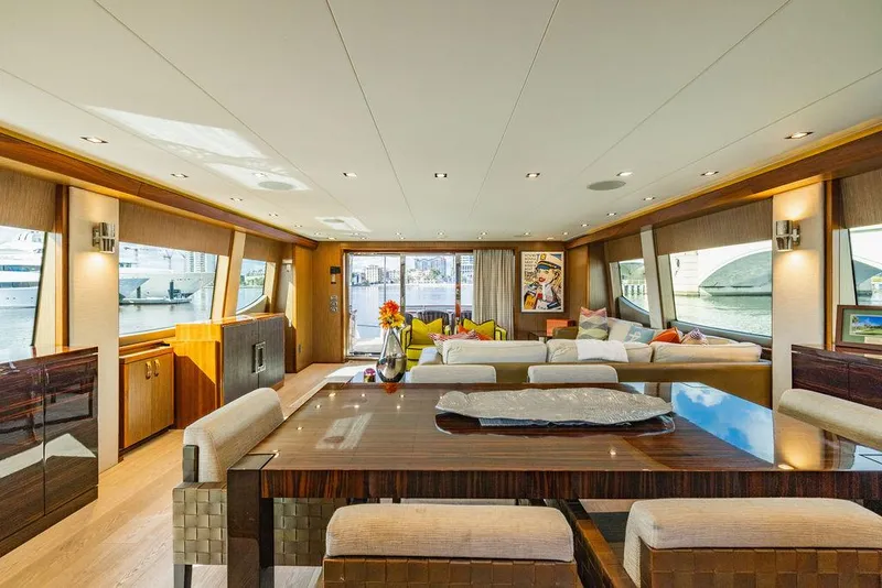 Slide: The Image of Luxurious interior of 2013 Hatteras 80 Motor Yacht with elegant dining area and panoramic windows. - 44