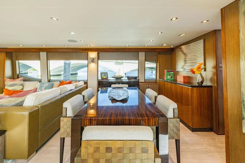 Slide: The Image of Luxurious interior of 2013 Hatteras 80 Motor Yacht with elegant dining area and plush seating. - 47
