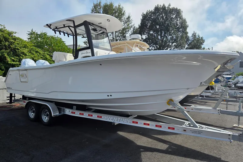 The Image of 2026 Sea Hunt Gamefish 25 boat on trailer, parked outdoors. - 1