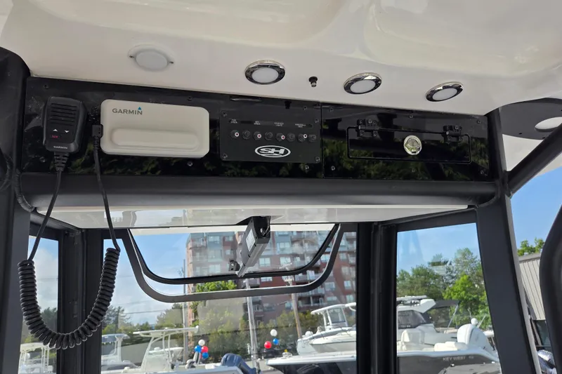 Slide: The Image of 2026 Sea Hunt Gamefish 25 boat console with Garmin electronics and control panel. - 11